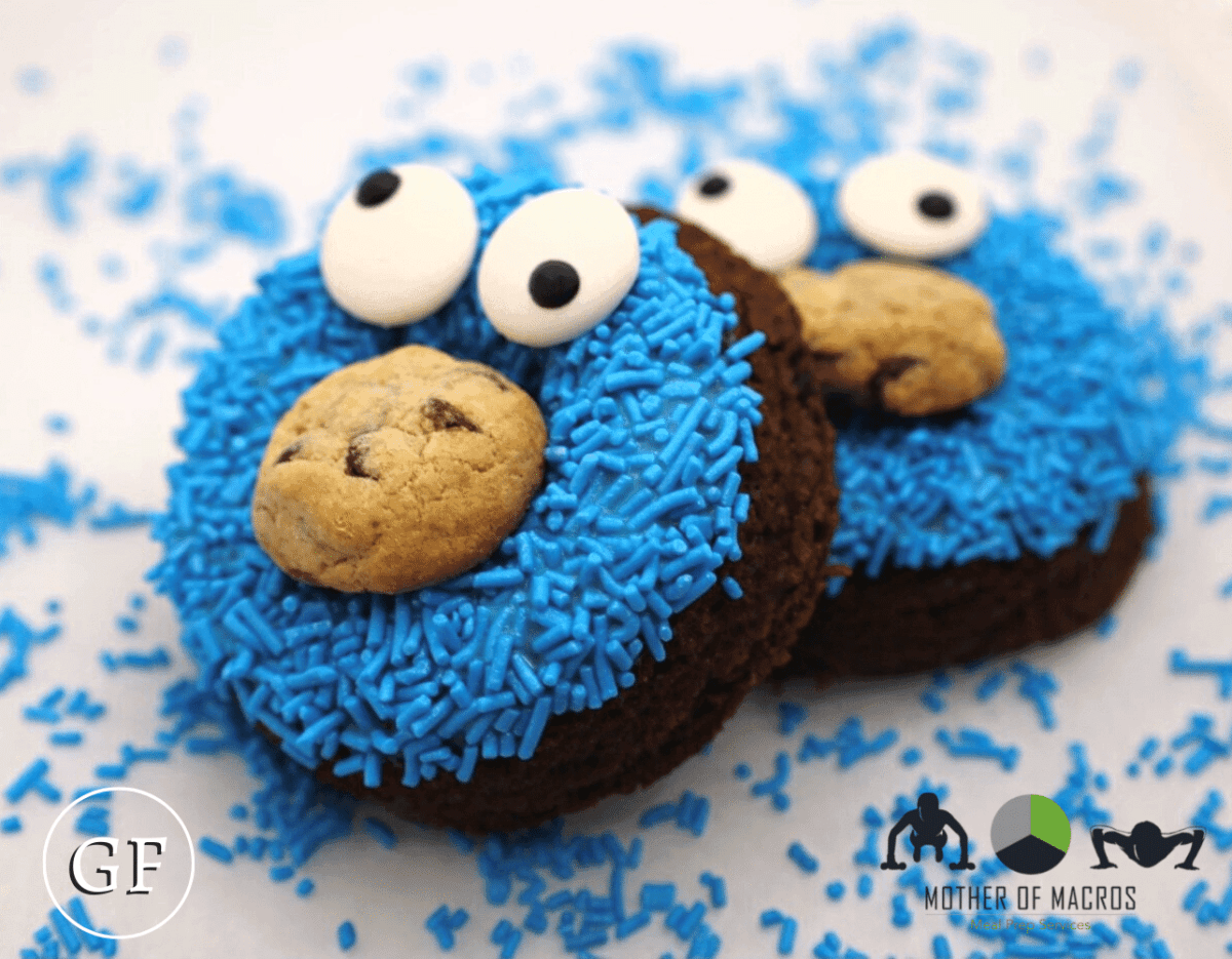 Gluten-free chocolate donuts topped with blue sprinkles, candy eyes, and a cookie center
